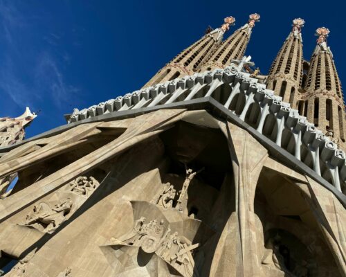 The ornate, towering cathedral of Sagrada Familia with elaborate spires and sculptures adorning the structure