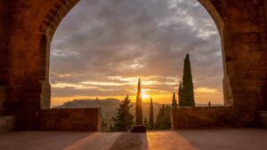 Sunset over Horta de Sant Joan as seen from the arched entrance of Convent of Sant Salvador d'Horta